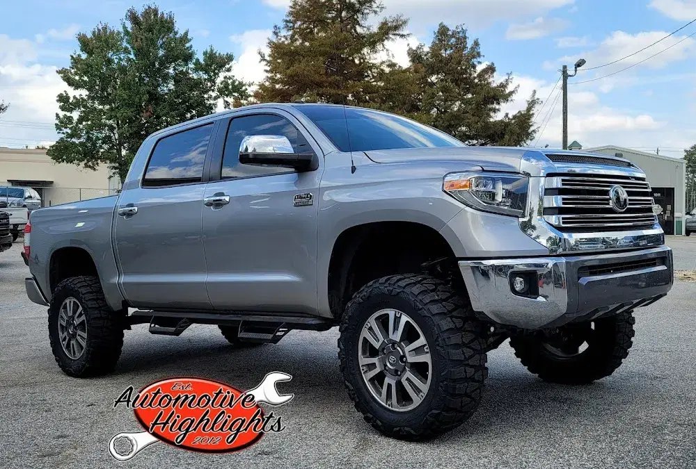 Lifted silver Toyota Tundra with all-terrain tires at Automotive Highlights